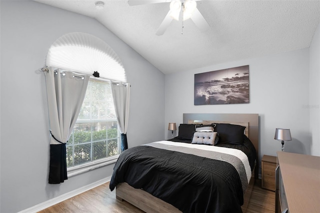 1584 Silhouette Dr, Clermont, FL 34711 - bedroom with vaulted ceiling, wood finished floors, ceiling fan, and a textured ceiling