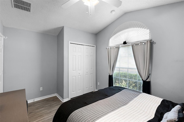 1584 Silhouette Dr, Clermont, FL 34711 - bedroom featuring wood finished floors, a closet, a textured ceiling, ceiling fan, and vaulted ceiling