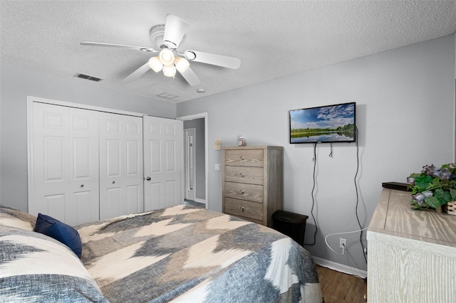 1584 Silhouette Dr, Clermont, FL 34711 - bedroom with a textured ceiling, a closet, wood finished floors, and a ceiling fan