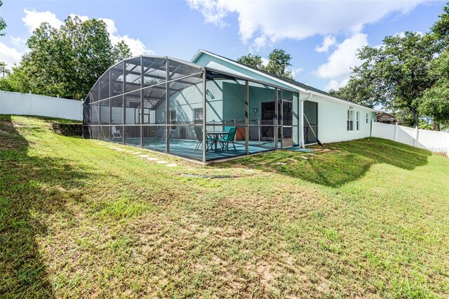 1584 Silhouette Dr, Clermont, FL 34711 - back of house with a fenced backyard, a lanai, and a patio