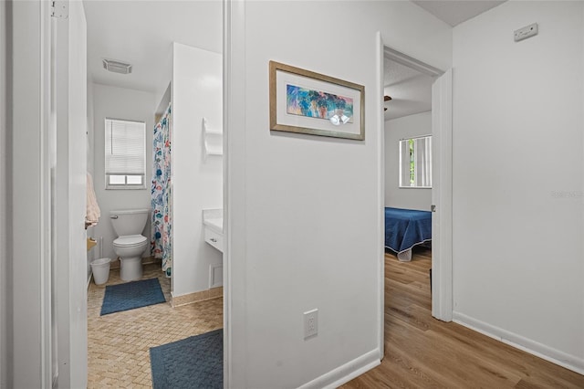 12178 Palmetto Way, Dunnellon, FL 34432 - corridor featuring baseboards and wood finished floors