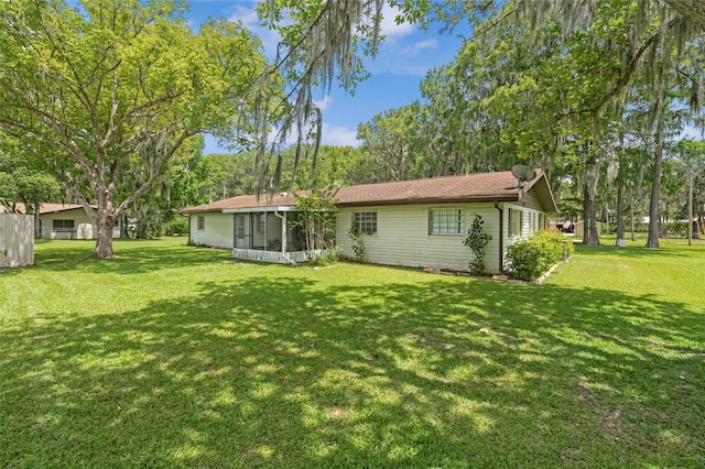 12178 Palmetto Way, Dunnellon, FL 34432 - back of house with a sunroom and a lawn