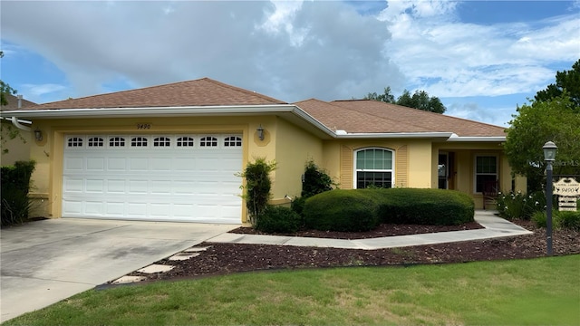 9490 SW 94th Ct, Ocala, FL 34481 - single story home with stucco siding, concrete driveway, a garage, and roof with shingles