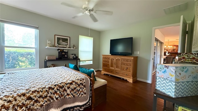 9490 SW 94th Ct, Ocala, FL 34481 - bedroom with wood finished floors, a chandelier, and a ceiling fan