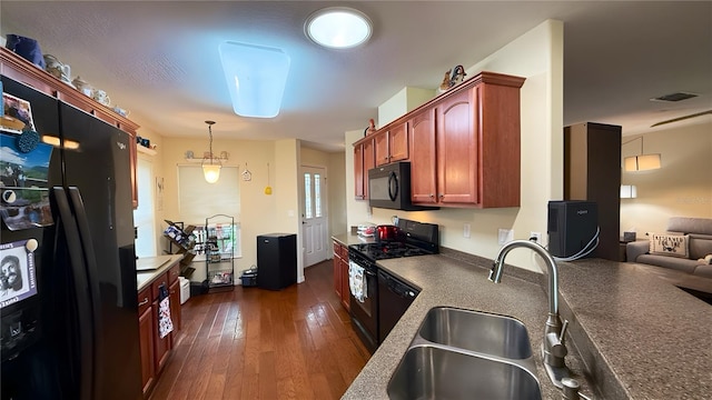 9490 SW 94th Ct, Ocala, FL 34481 - kitchen featuring black appliances, dark wood-style flooring, decorative light fixtures, dark countertops, and open floor plan