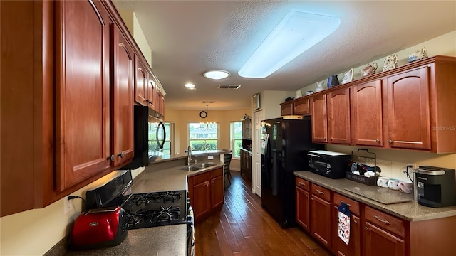 9490 SW 94th Ct, Ocala, FL 34481 - kitchen featuring black appliances, dark wood-type flooring, and hanging light fixtures