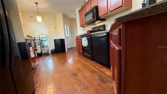 9490 SW 94th Ct, Ocala, FL 34481 - kitchen with black appliances, hardwood / wood-style flooring, decorative light fixtures, dark countertops, and dark brown cabinets