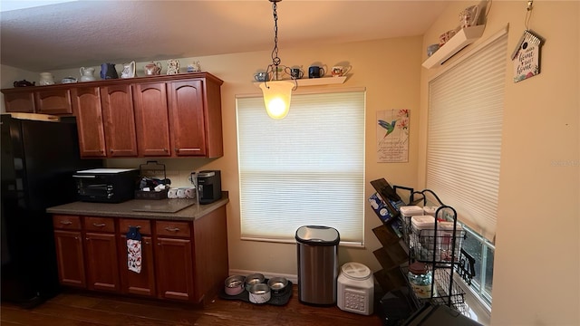 9490 SW 94th Ct, Ocala, FL 34481 - kitchen featuring freestanding refrigerator, dark wood-type flooring, and decorative light fixtures