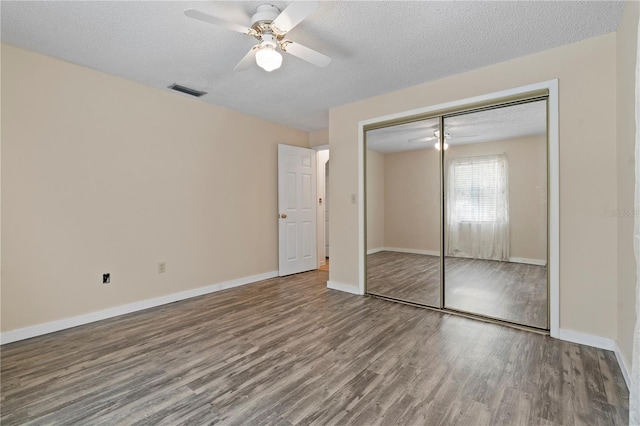 206 N Dundee Way, Inverness, FL 34450 - unfurnished bedroom with wood finished floors, a closet, a ceiling fan, and a textured ceiling