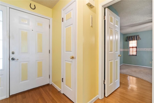 206 N Dundee Way, Inverness, FL 34450 - corridor with a textured ceiling and light wood-type flooring