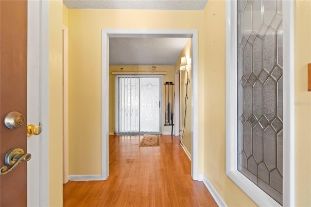 206 N Dundee Way, Inverness, FL 34450 - corridor featuring light wood-style flooring and a textured ceiling