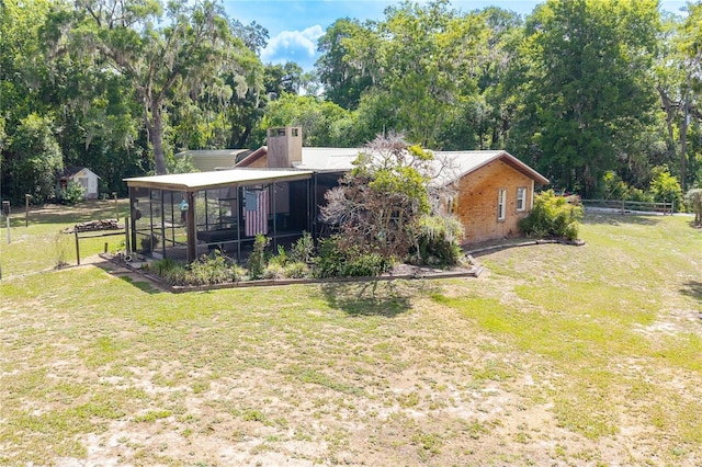 206 N Dundee Way, Inverness, FL 34450 - rear view of house with a sunroom, a carport, and view of scattered trees