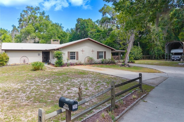 206 N Dundee Way, Inverness, FL 34450 - ranch-style home featuring a detached carport, concrete driveway, and a chimney