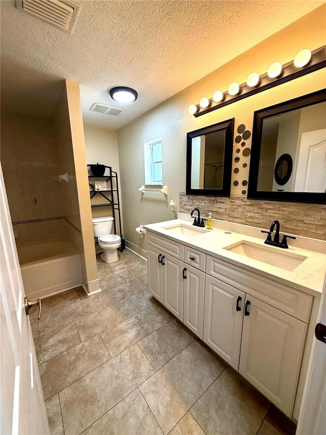 2550 SW Ivy Pl, Dunnellon, FL 34431 - bathroom with double vanity, tasteful backsplash, a textured ceiling, tile patterned floors, and tub / shower combination