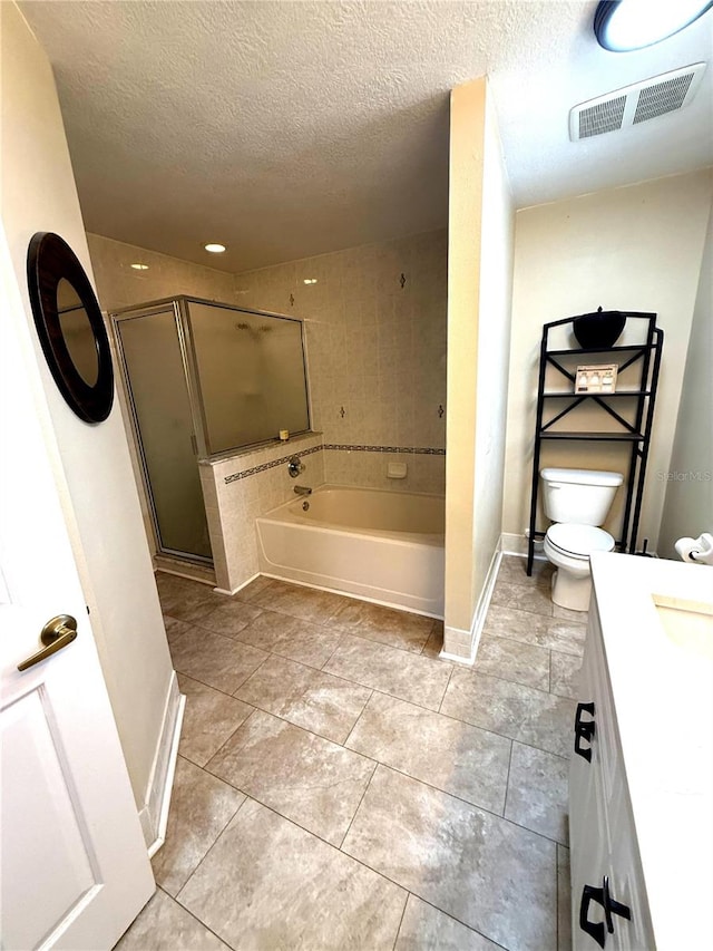 2550 SW Ivy Pl, Dunnellon, FL 34431 - bathroom featuring a bath, vanity, a shower stall, a textured ceiling, and tile patterned floors
