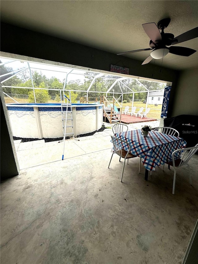2550 SW Ivy Pl, Dunnellon, FL 34431 - view of patio / terrace featuring a lanai, a ceiling fan, and an outdoor pool