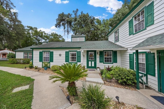 7961 Midway Drive Ter Unit J102, Ocala, FL 34472 - view of front facade with a front lawn and a shingled roof