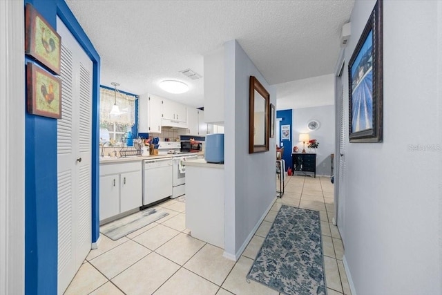 7961 Midway Drive Ter Unit J102, Ocala, FL 34472 - hall featuring light tile patterned floors and a textured ceiling