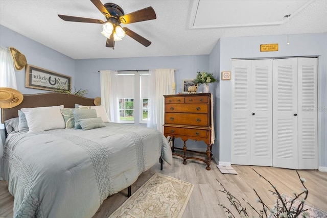 7961 Midway Drive Ter Unit J102, Ocala, FL 34472 - bedroom with wood finished floors, a closet, ceiling fan, and a textured ceiling
