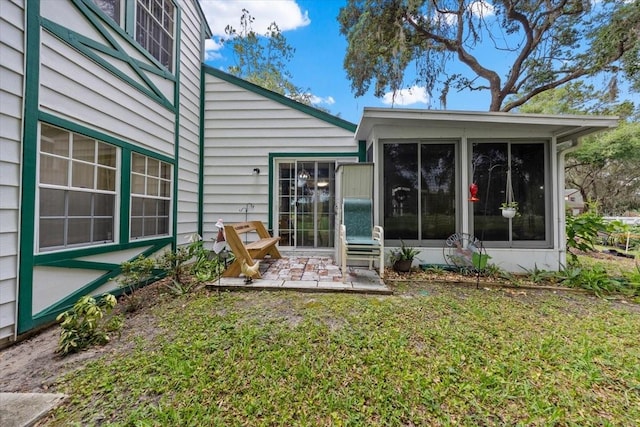 7961 Midway Drive Ter Unit J102, Ocala, FL 34472 - back of house with a sunroom, a patio, and a yard