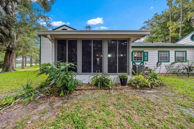 7961 Midway Drive Ter Unit J102, Ocala, FL 34472 - back of house featuring a sunroom and a lawn