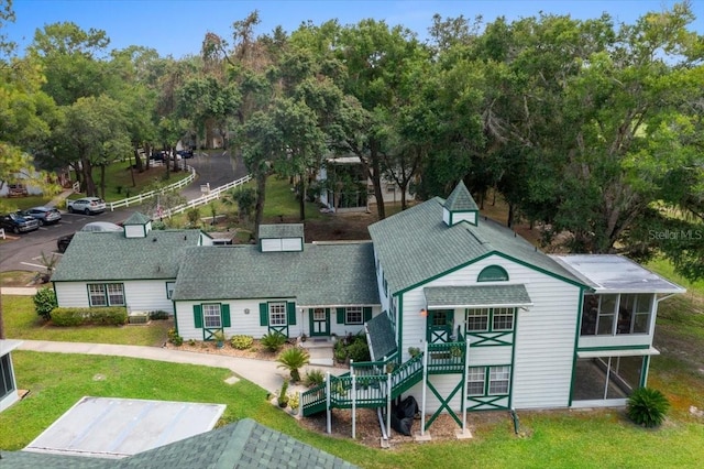 7961 Midway Drive Ter Unit J102, Ocala, FL 34472 - view of front of house featuring a sunroom, a front lawn, and stairway