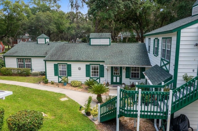 7961 Midway Drive Ter Unit J102, Ocala, FL 34472 - view of front of home featuring a front yard and roof with shingles