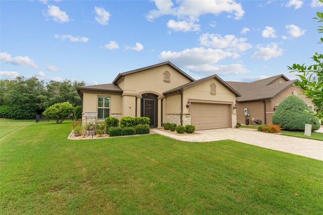 7839 SW 97th Cir, Ocala, FL 34481 - view of front facade featuring stucco siding, decorative driveway, an attached garage, and a front lawn