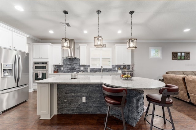 7839 SW 97th Cir, Ocala, FL 34481 - kitchen with appliances with stainless steel finishes, a kitchen island, decorative backsplash, open floor plan, and dark wood-type flooring
