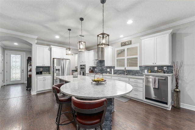 7839 SW 97th Cir, Ocala, FL 34481 - kitchen featuring appliances with stainless steel finishes, tasteful backsplash, a breakfast bar, white cabinetry, and recessed lighting
