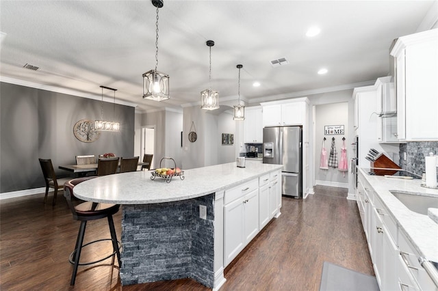 7839 SW 97th Cir, Ocala, FL 34481 - kitchen featuring stainless steel refrigerator with ice dispenser, recessed lighting, a center island, white cabinetry, and ornamental molding