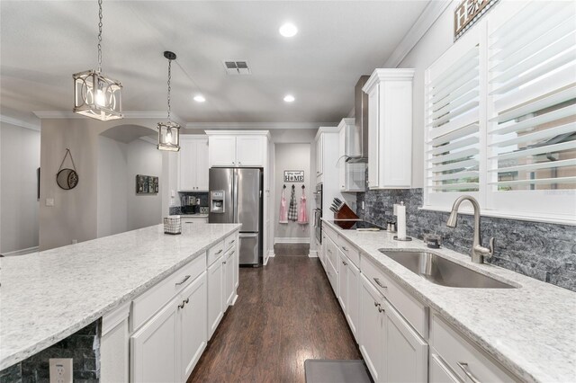 7839 SW 97th Cir, Ocala, FL 34481 - kitchen featuring stainless steel refrigerator with ice dispenser, crown molding, backsplash, white cabinetry, and pendant lighting