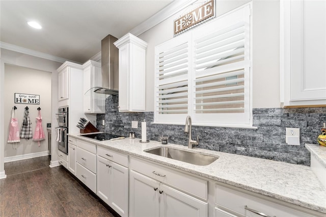 7839 SW 97th Cir, Ocala, FL 34481 - kitchen with wall chimney range hood, double oven, white cabinets, backsplash, and crown molding