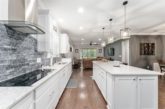 7839 SW 97th Cir, Ocala, FL 34481 - kitchen featuring ventilation hood, black electric cooktop, open floor plan, a center island, and crown molding