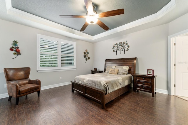 7839 SW 97th Cir, Ocala, FL 34481 - bedroom featuring a tray ceiling, ornamental molding, dark wood-style flooring, a textured ceiling, and a ceiling fan