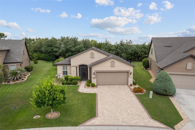 7839 SW 97th Cir, Ocala, FL 34481 - view of front of home with stucco siding, driveway, a front yard, and an attached garage