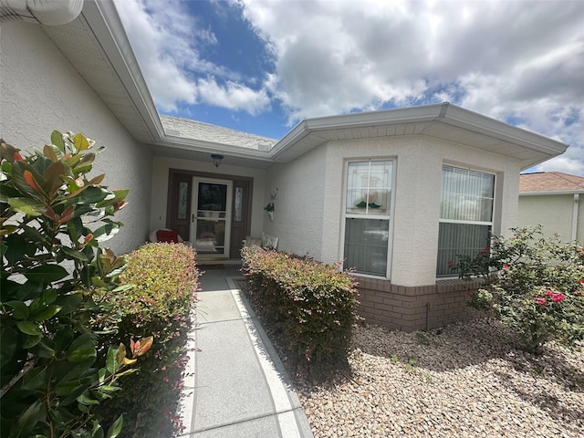9730 SW 90th St, Ocala, FL 34481 - doorway to property with stucco siding and a shingled roof