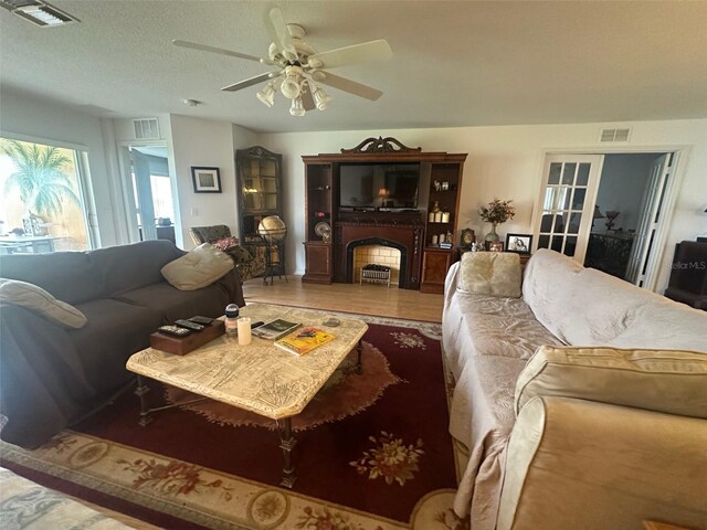 9730 SW 90th St, Ocala, FL 34481 - living room featuring a ceiling fan, a fireplace, and wood finished floors