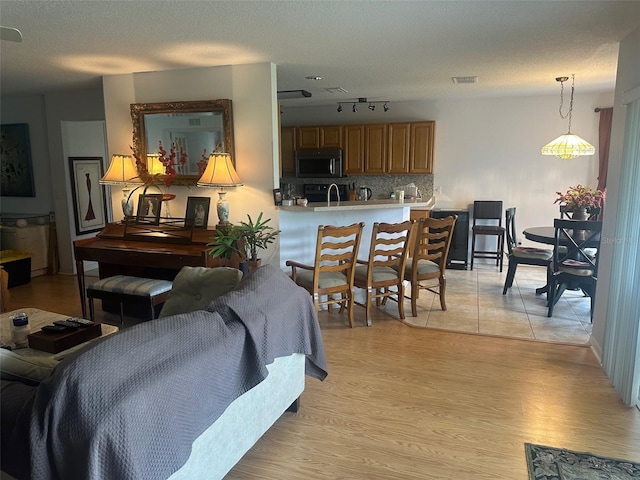 9730 SW 90th St, Ocala, FL 34481 - living area with light wood-style flooring and a textured ceiling
