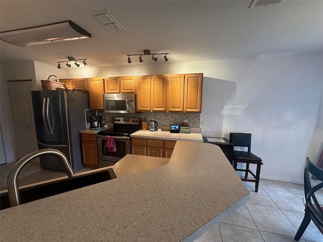 9730 SW 90th St, Ocala, FL 34481 - kitchen with stainless steel appliances, tasteful backsplash, light countertops, and light tile patterned flooring