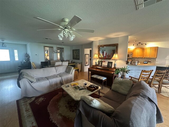 9730 SW 90th St, Ocala, FL 34481 - living room with ceiling fan, light wood-style floors, and a textured ceiling