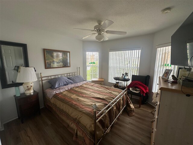 9730 SW 90th St, Ocala, FL 34481 - bedroom featuring multiple windows, dark wood-type flooring, a textured ceiling, and ceiling fan