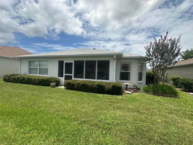 9730 SW 90th St, Ocala, FL 34481 - back of house featuring a lawn and stucco siding
