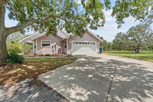 10230 289th St E, Myakka City, FL 34251 - view of front of property with driveway, an attached garage, and a front yard