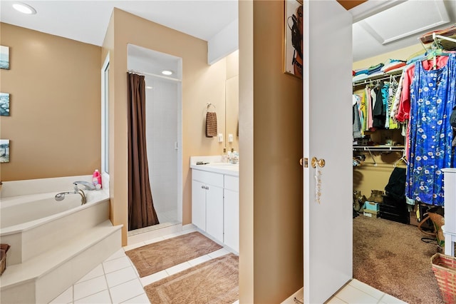 10230 289th St E, Myakka City, FL 34251 - full bathroom with a stall shower, a spacious closet, a bath, tile patterned floors, and vanity