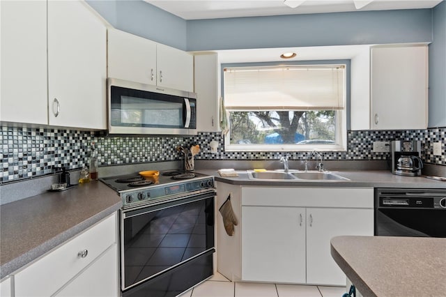 10230 289th St E, Myakka City, FL 34251 - kitchen featuring stainless steel microwave, electric range, black dishwasher, white cabinetry, and tasteful backsplash