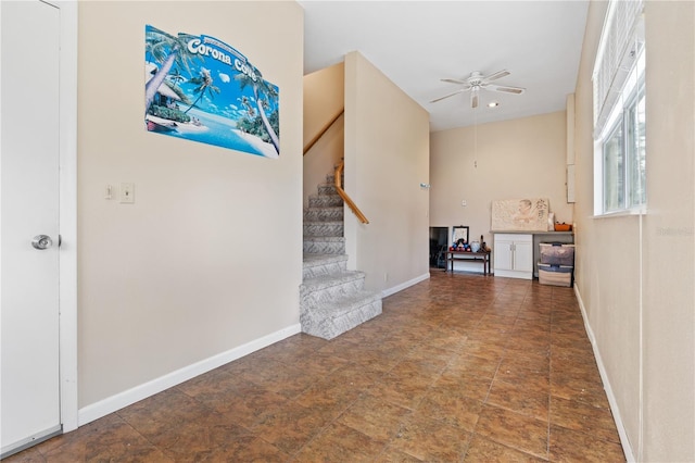 10230 289th St E, Myakka City, FL 34251 - unfurnished living room with a ceiling fan, stairs, and stone finish floors