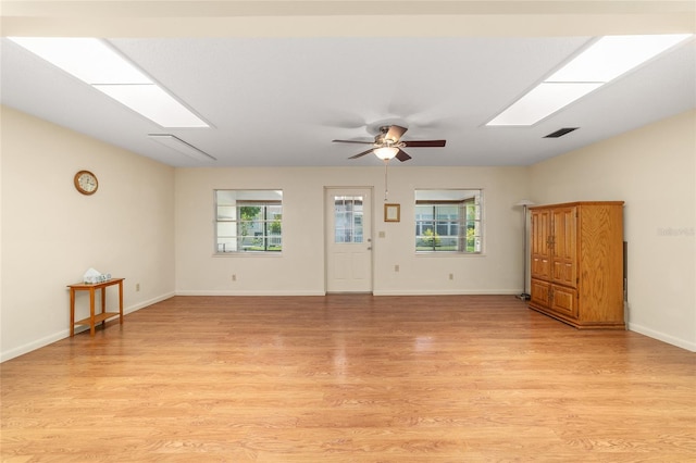 8704 SW 94th Ln Unit G, Ocala, FL 34481 - unfurnished room with light wood-style flooring, plenty of natural light, a ceiling fan, and a skylight