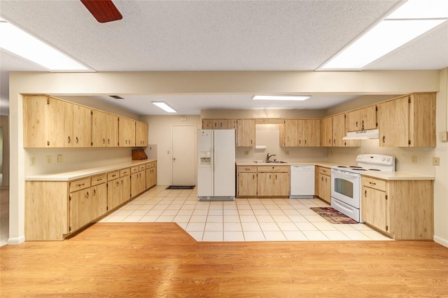 8704 SW 94th Ln Unit G, Ocala, FL 34481 - kitchen with white appliances, under cabinet range hood, light brown cabinets, and light countertops