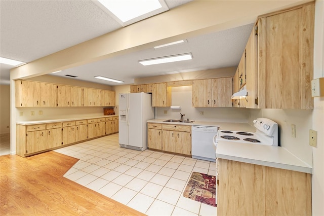 8704 SW 94th Ln Unit G, Ocala, FL 34481 - kitchen with white appliances, light brown cabinets, light countertops, and under cabinet range hood